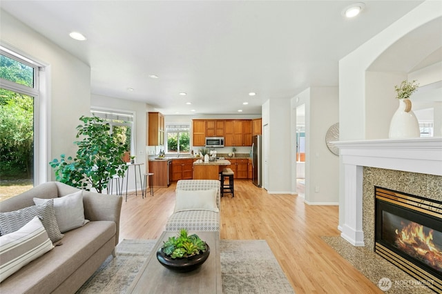 3303 174th Pl SE, Bothell, WA 98012 - living area with a fireplace, light wood-type flooring, and recessed lighting