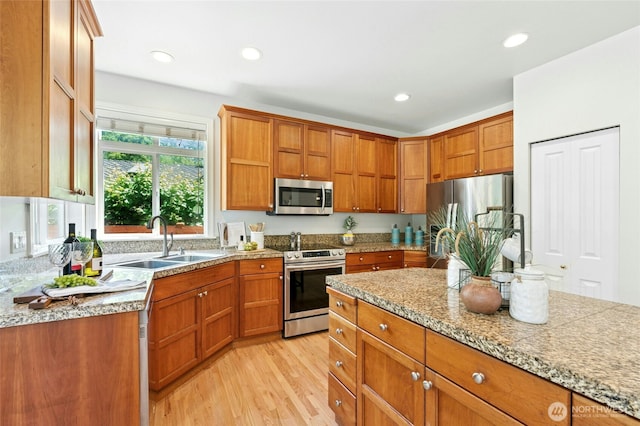 3303 174th Pl SE, Bothell, WA 98012 - kitchen featuring stainless steel appliances, light wood-type flooring, brown cabinetry, and recessed lighting