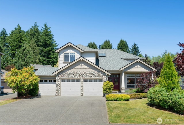 3303 174th Pl SE, Bothell, WA 98012 - craftsman-style home featuring an attached garage, stone siding, concrete driveway, a front lawn, and a shingled roof