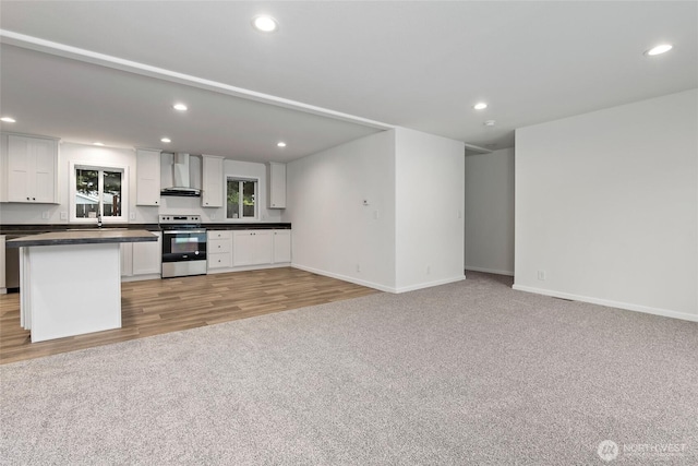 25405 36th Ave E, Spanaway, WA 98387 - kitchen with wall chimney exhaust hood, stainless steel electric range oven, dark countertops, white cabinets, and recessed lighting