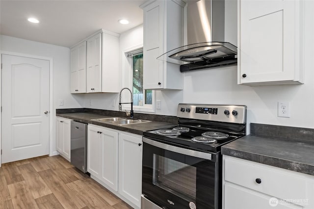 25405 36th Ave E, Spanaway, WA 98387 - kitchen featuring appliances with stainless steel finishes, wall chimney range hood, dark countertops, white cabinets, and recessed lighting
