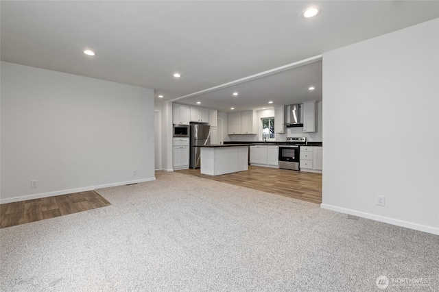 25405 36th Ave E, Spanaway, WA 98387 - unfurnished living room with light carpet, recessed lighting, and light wood-style flooring