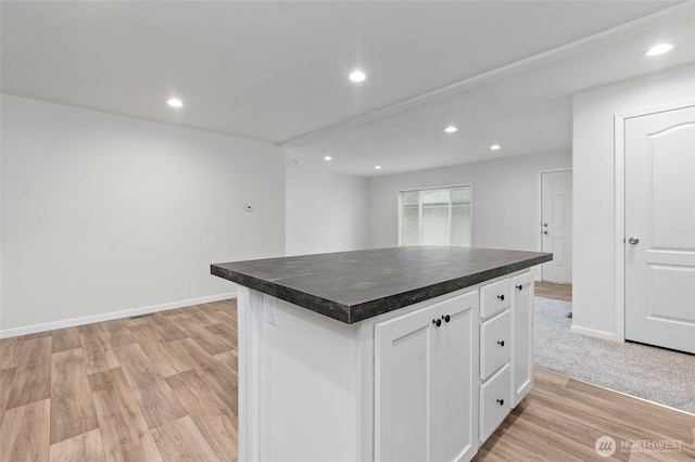25405 36th Ave E, Spanaway, WA 98387 - kitchen with dark countertops, white cabinets, light wood-style floors, recessed lighting, and a center island