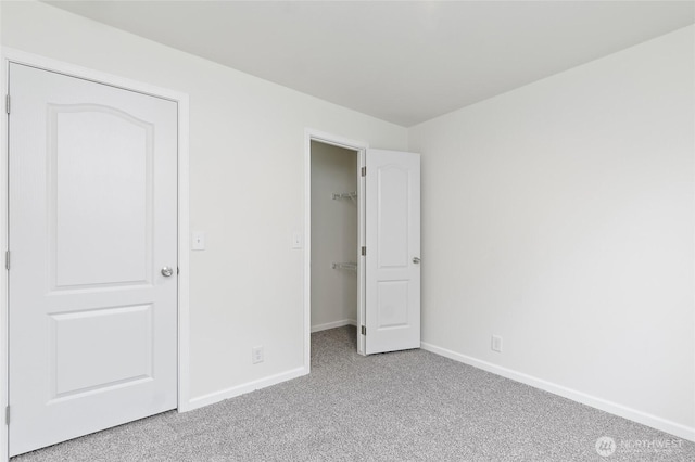 25405 36th Ave E, Spanaway, WA 98387 - unfurnished bedroom featuring carpet floors, a walk in closet, and a closet