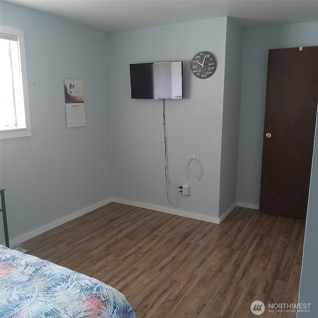11072 Peacock Ln, Burlington, WA 98233 - unfurnished bedroom featuring wood finished floors and baseboards