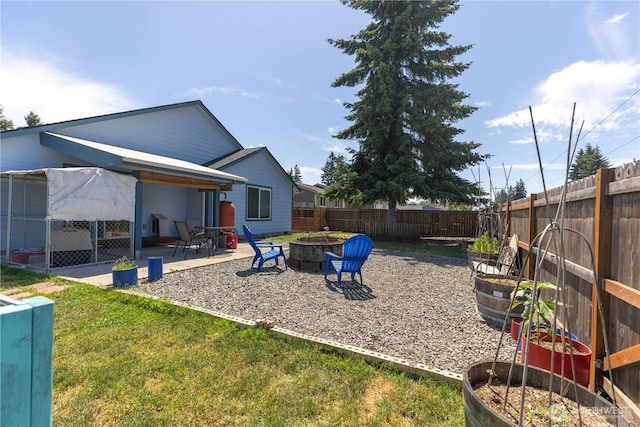 6321 199th Loop SW, Rochester, WA 98579 - fenced backyard with an outdoor fire pit and a patio area