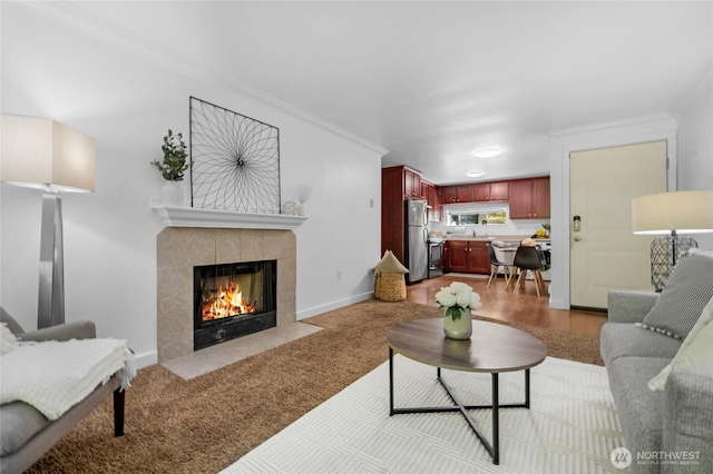 23405 16th Pl S Unit C104, Des Moines, WA 98198 - living area featuring a tile fireplace, crown molding, and light colored carpet