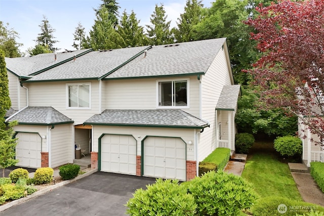 1131 115th St SW Unit E4, Everett, WA 98204 - view of front facade with a shingled roof, a garage, asphalt driveway, and brick siding