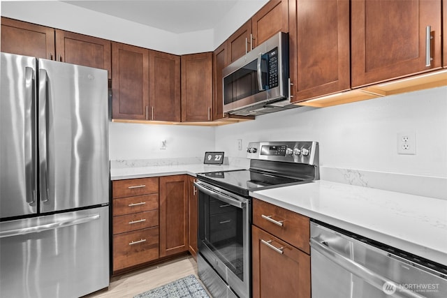 1131 115th St SW Unit E4, Everett, WA 98204 - kitchen featuring appliances with stainless steel finishes, light countertops, and light wood-type flooring