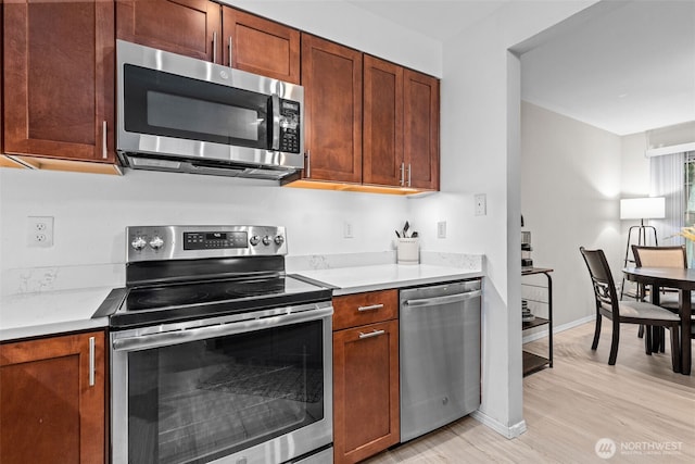 1131 115th St SW Unit E4, Everett, WA 98204 - kitchen featuring stainless steel appliances, light wood finished floors, and light countertops