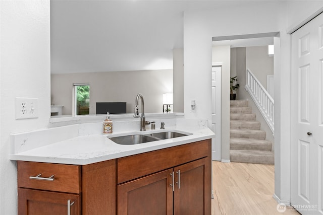 1131 115th St SW Unit E4, Everett, WA 98204 - kitchen featuring light wood-style flooring, light stone counters, and brown cabinetry