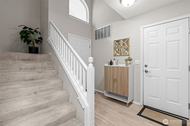 1131 115th St SW Unit E4, Everett, WA 98204 - entryway with light wood-style flooring, stairway, and a high ceiling