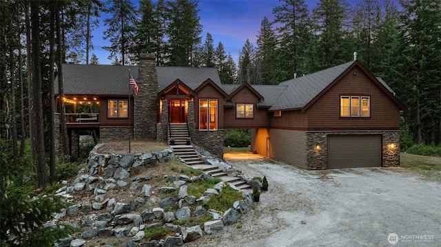 16060 Telemark Ln, Leavenworth, WA 98826 - view of front facade featuring stone siding, a garage, dirt driveway, stairway, and a chimney