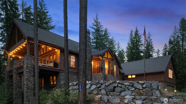16060 Telemark Ln, Leavenworth, WA 98826 - back of property featuring a balcony, stone siding, and a chimney