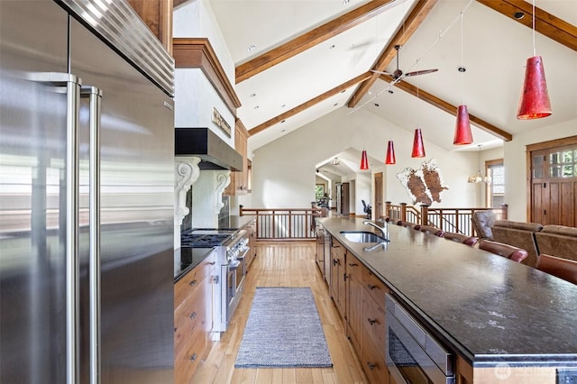16060 Telemark Ln, Leavenworth, WA 98826 - kitchen featuring appliances with stainless steel finishes, light wood-type flooring, beamed ceiling, a ceiling fan, and a large island