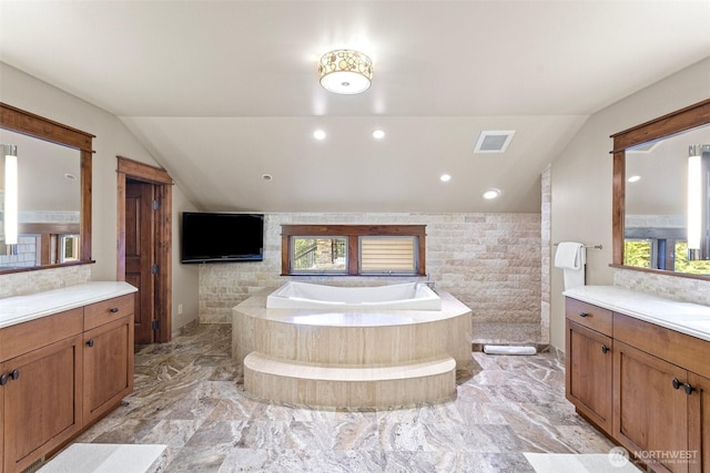 16060 Telemark Ln, Leavenworth, WA 98826 - full bath with lofted ceiling, marble tiled floors, vanity, and a garden tub