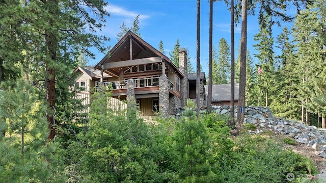 16060 Telemark Ln, Leavenworth, WA 98826 - rear view of house with a chimney, stone siding, and board and batten siding