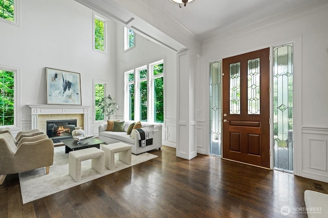 4935 163rd Pl SE, Bellevue, WA 98006 - entryway featuring a decorative wall, ornamental molding, dark wood-style flooring, a fireplace, and wainscoting