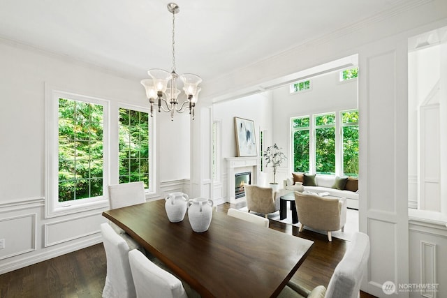 4935 163rd Pl SE, Bellevue, WA 98006 - dining room with a decorative wall, a chandelier, healthy amount of natural light, ornamental molding, and dark wood finished floors
