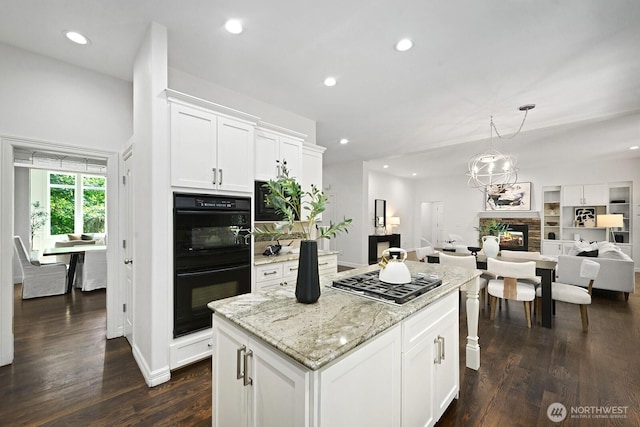 4935 163rd Pl SE, Bellevue, WA 98006 - kitchen featuring stainless steel gas stovetop, a center island, open floor plan, a stone fireplace, and recessed lighting