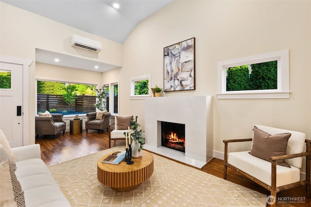 2939 36th Ave S, Seattle, WA 98144 - living room with a wall mounted air conditioner, a premium fireplace, wood finished floors, and high vaulted ceiling
