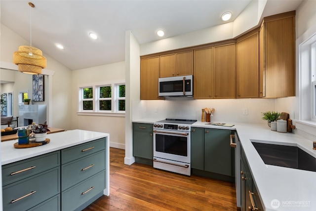 2939 36th Ave S, Seattle, WA 98144 - kitchen with stainless steel appliances, light countertops, dark wood-style floors, tasteful backsplash, and vaulted ceiling