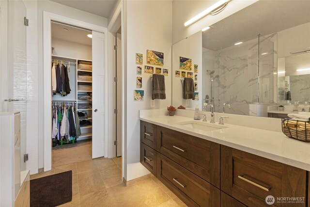 4907 Main St Unit 207, Tacoma, WA 98407 - bathroom with a marble finish shower, vanity, a spacious closet, and tile patterned flooring