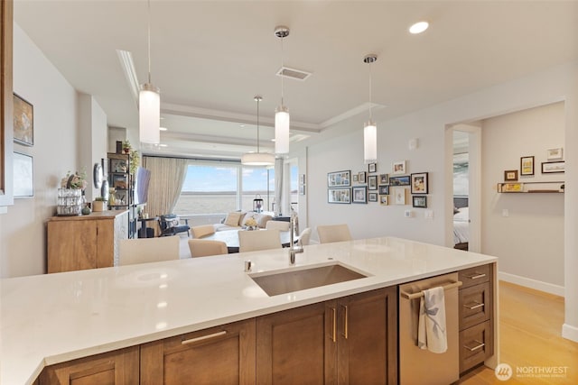 4907 Main St Unit 207, Tacoma, WA 98407 - kitchen featuring brown cabinetry, pendant lighting, stainless steel dishwasher, light countertops, and recessed lighting