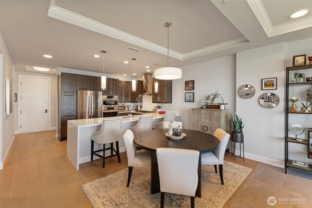 4907 Main St Unit 207, Tacoma, WA 98407 - dining room with ornamental molding, light wood finished floors, a tray ceiling, and recessed lighting