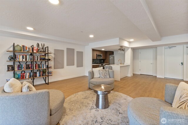 4907 Main St Unit 207, Tacoma, WA 98407 - living room with light wood-style floors, a textured ceiling, and recessed lighting