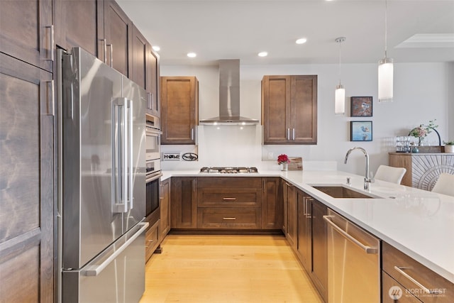 4907 Main St Unit 207, Tacoma, WA 98407 - kitchen with wall chimney range hood, stainless steel appliances, light wood-style flooring, light countertops, and recessed lighting