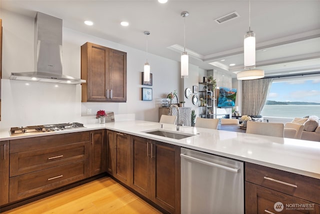 4907 Main St Unit 207, Tacoma, WA 98407 - kitchen featuring appliances with stainless steel finishes, wall chimney range hood, light countertops, pendant lighting, and recessed lighting