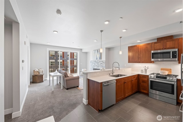 4961 Main St Unit 719, Tacoma, WA 98407 - kitchen with stainless steel appliances, a peninsula, open floor plan, light countertops, and pendant lighting