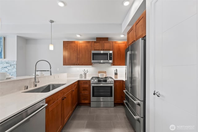 4961 Main St Unit 719, Tacoma, WA 98407 - kitchen featuring stainless steel appliances, brown cabinets, recessed lighting, light countertops, and dark tile patterned flooring