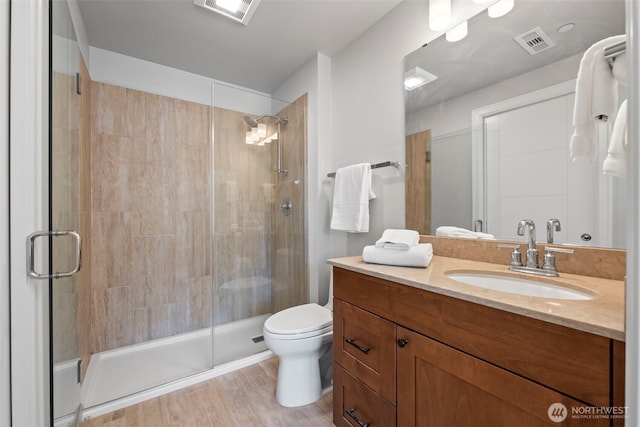 4961 Main St Unit 719, Tacoma, WA 98407 - bathroom featuring vanity, a stall shower, and wood finished floors