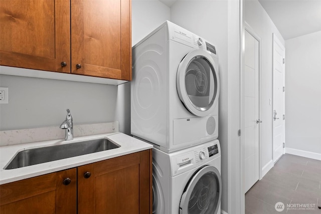 4961 Main St Unit 719, Tacoma, WA 98407 - washroom featuring stacked washer / drying machine, cabinet space, and tile patterned floors