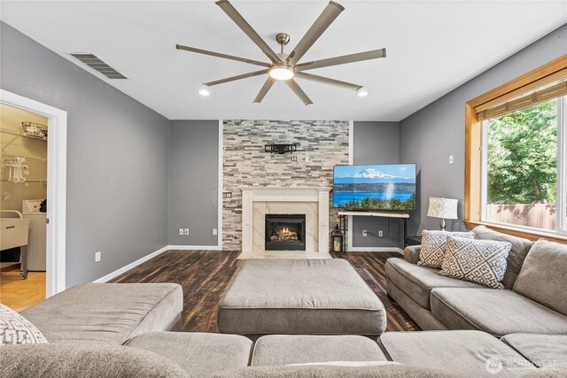 20523 193rd Avenue Ct E, Orting, WA 98360 - living room with a ceiling fan, wood finished floors, washer / dryer, and a tile fireplace