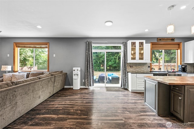 20523 193rd Avenue Ct E, Orting, WA 98360 - kitchen with white cabinetry, dark wood finished floors, wooden counters, glass insert cabinets, and open floor plan