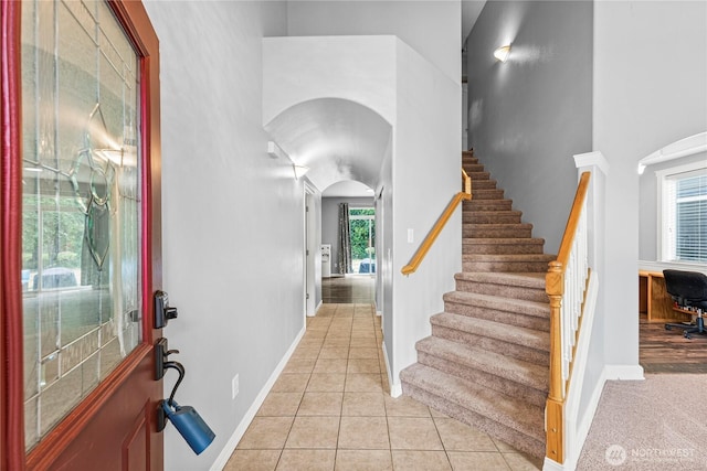 20523 193rd Avenue Ct E, Orting, WA 98360 - entrance foyer with arched walkways, a high ceiling, stairs, and light tile patterned flooring