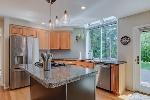 18915 SE 284th Ct, Kent, WA 98042 - kitchen featuring appliances with stainless steel finishes, light wood-style floors, dark stone countertops, a center island, and recessed lighting