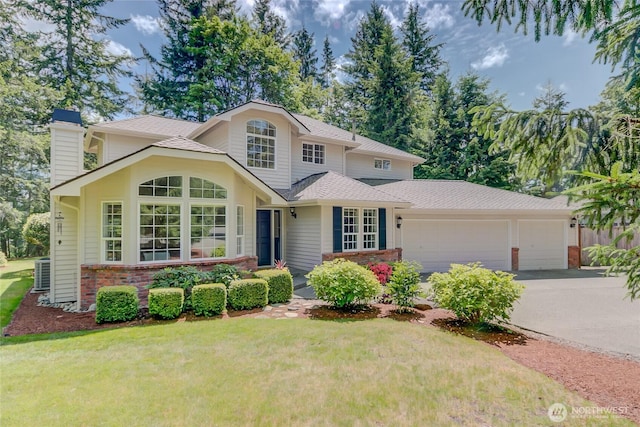 18915 SE 284th Ct, Kent, WA 98042 - traditional-style home with a garage, a chimney, driveway, brick siding, and a front lawn