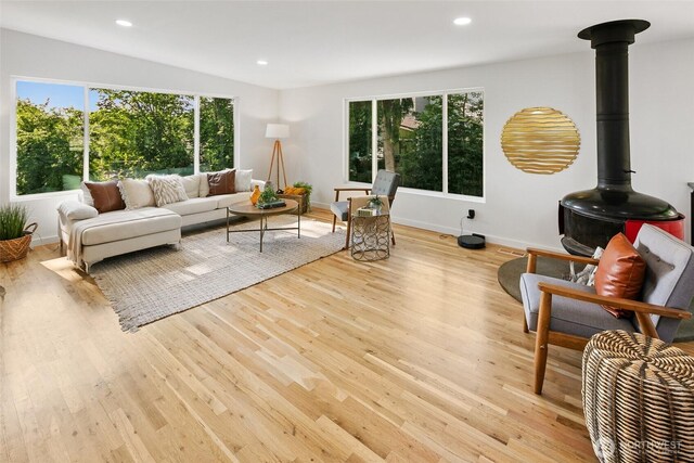 12569 37th Ave NE, Seattle, WA 98125 - living area with plenty of natural light, a wood stove, wood finished floors, and recessed lighting
