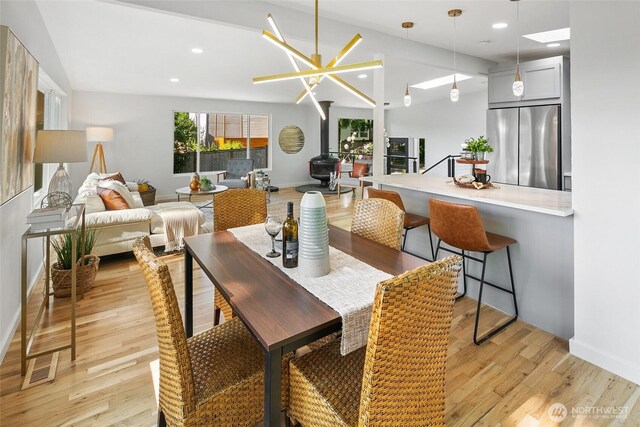 12569 37th Ave NE, Seattle, WA 98125 - dining area with light wood-type flooring, recessed lighting, and a wood stove