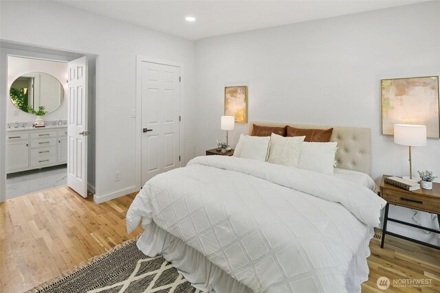 12569 37th Ave NE, Seattle, WA 98125 - bedroom with light wood-style flooring, recessed lighting, and connected bathroom