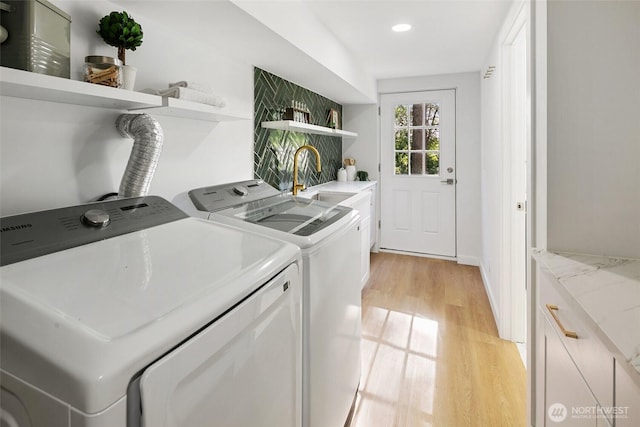 12569 37th Ave NE, Seattle, WA 98125 - washroom with cabinet space, separate washer and dryer, light wood-style flooring, and recessed lighting