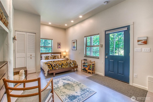 87 Levon Ln, Orcas Island, WA 98243 - bedroom with multiple windows, recessed lighting, concrete flooring, a closet, and a towering ceiling