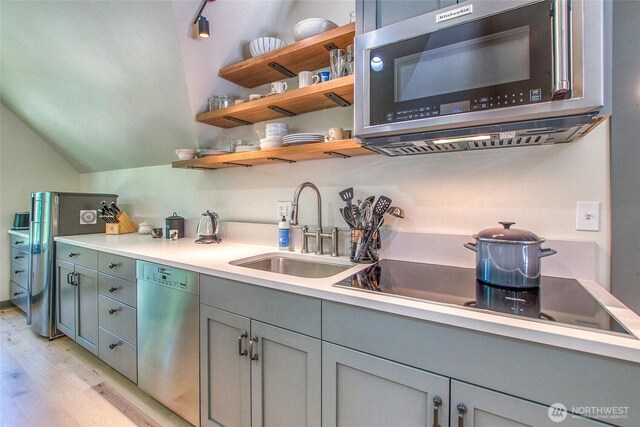 87 Levon Ln, Orcas Island, WA 98243 - kitchen with appliances with stainless steel finishes, light wood-type flooring, light countertops, gray cabinetry, and lofted ceiling