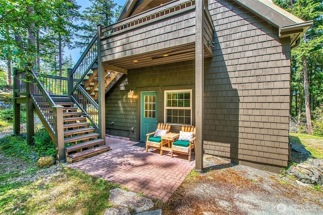 87 Levon Ln, Orcas Island, WA 98243 - rear view of house featuring stairs, a deck, and a patio area