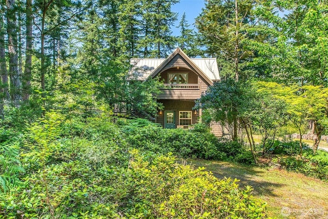 87 Levon Ln, Orcas Island, WA 98243 - view of property exterior with a standing seam roof, a metal roof, and a balcony