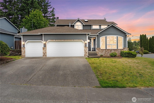 27628 221st Ave SE, Maple Valley, WA 98038 - traditional-style house featuring an attached garage, driveway, a lawn, and brick siding